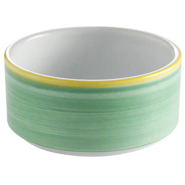 A green porcelain soup cup with a white rim.