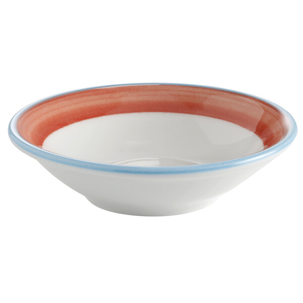 A white porcelain monkey dish with a blue rim decorated with coral and blue monkey designs.