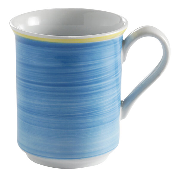 A white porcelain mug with a blue and yellow rim and a blue handle.