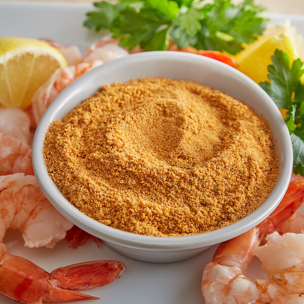 A bowl of shrimp seasoned with J.O. No. 1 Seafood Seasoning and lemon.