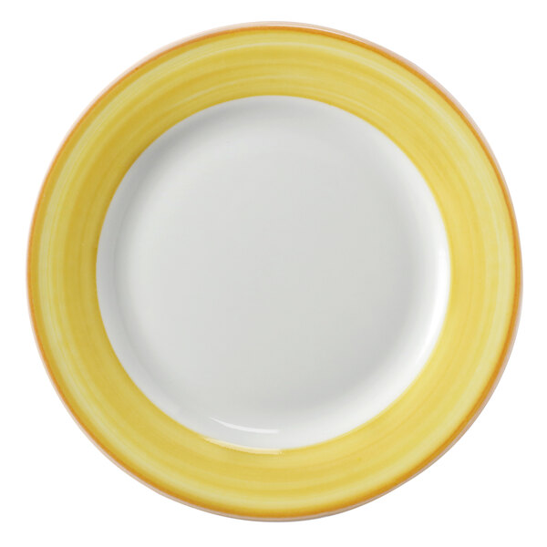 A close-up of a Corona Calypso porcelain plate with a yellow and white rim.