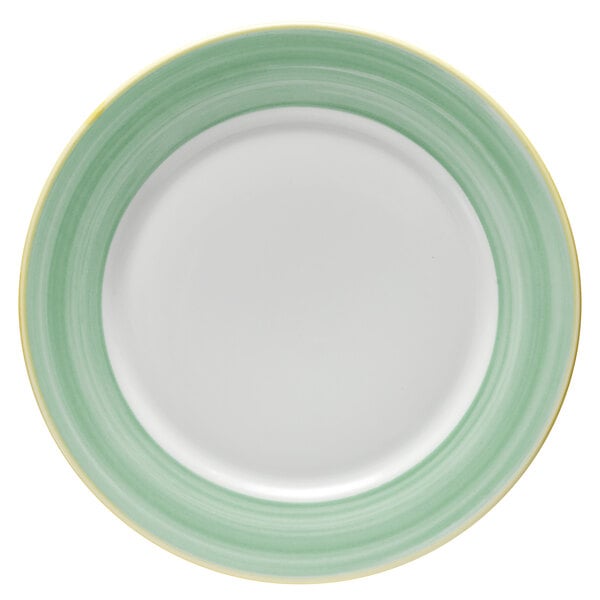 A bright white porcelain plate with a green and yellow rim.