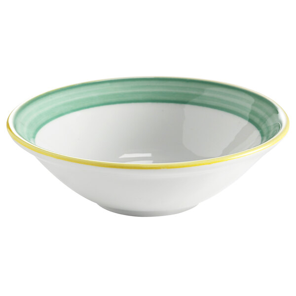 A white porcelain Corona bowl with a green rim and yellow stripe.