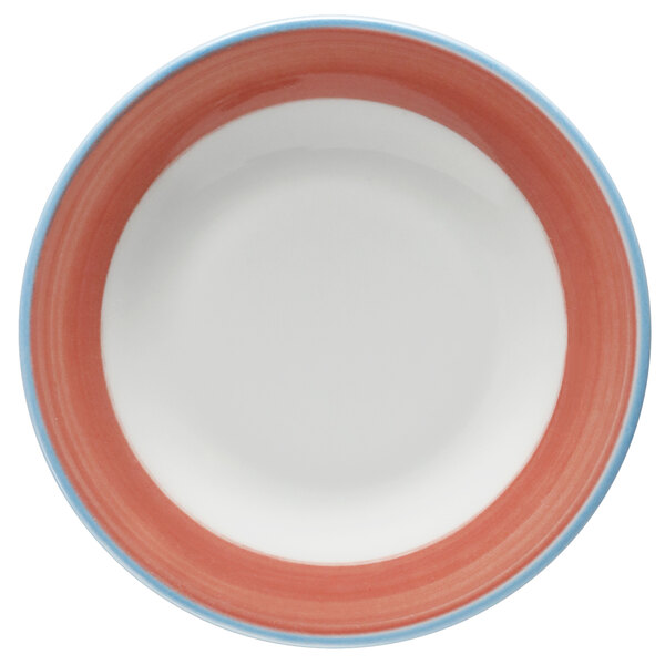 A bright white porcelain plate with a blue and coral rim.