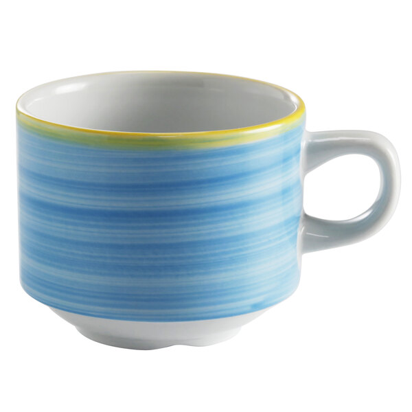 A blue porcelain tea cup with a blue and yellow striped pattern on it.