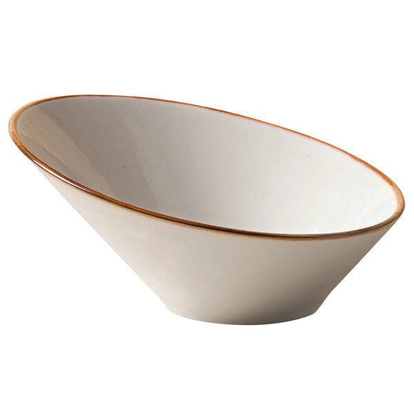 A beige porcelain bowl with a slanted design and brown rim.