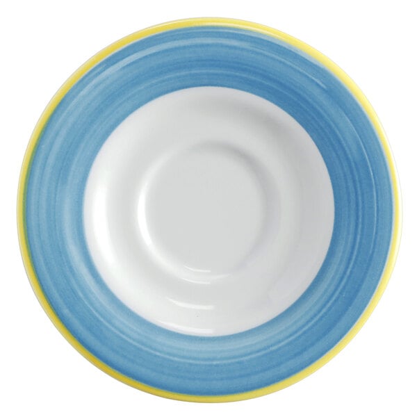 A close-up of a Corona bright white porcelain saucer with a blue and yellow rim.