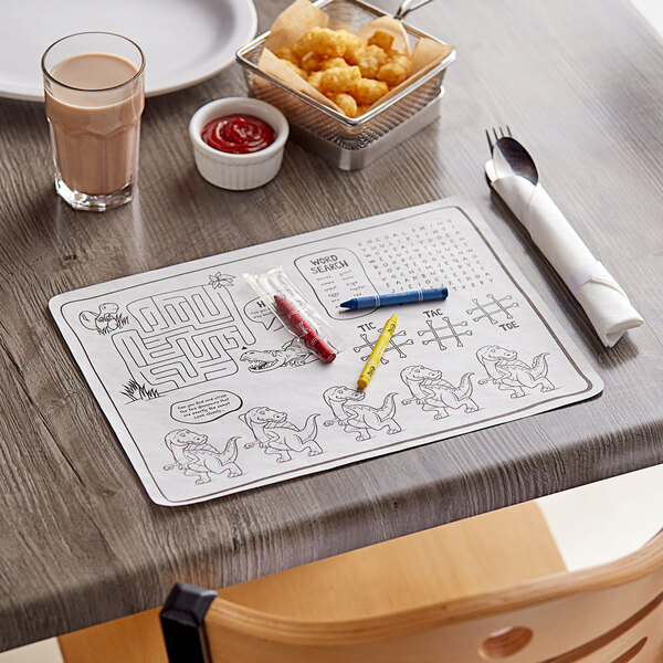A wood table set with a Choice Kids Dinosaur Interactive Placemat with food and a drink.