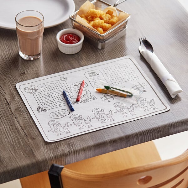 A table with a Choice kids dinosaur place mat and crayons.