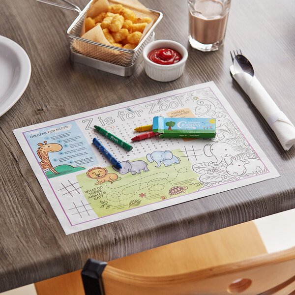 A table with a zoo themed Kids' Choice Interactive Placemat and food on it.