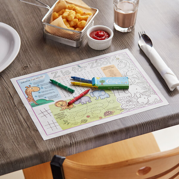A table with a Choice zoo-themed kids placemat and food on it.