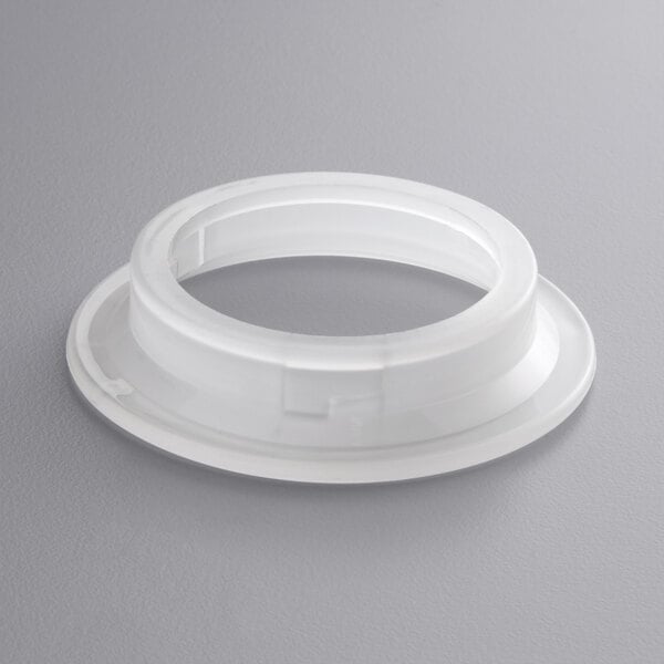 A white plastic round flange with a hole.