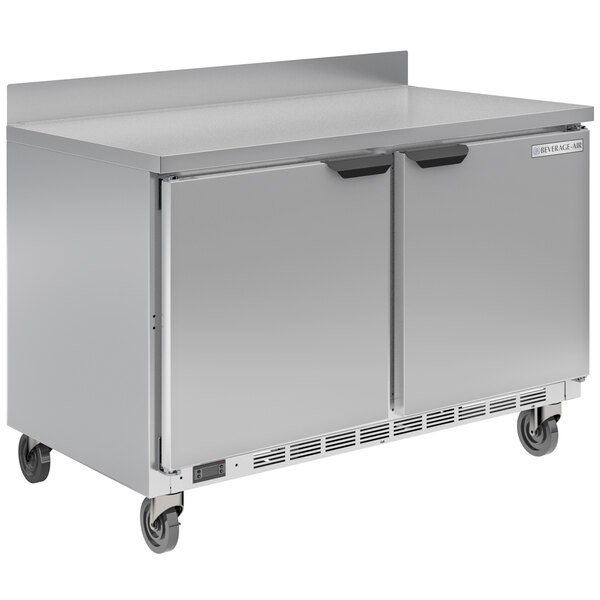 A stainless steel Beverage-Air worktop refrigerator with two doors on wheels.