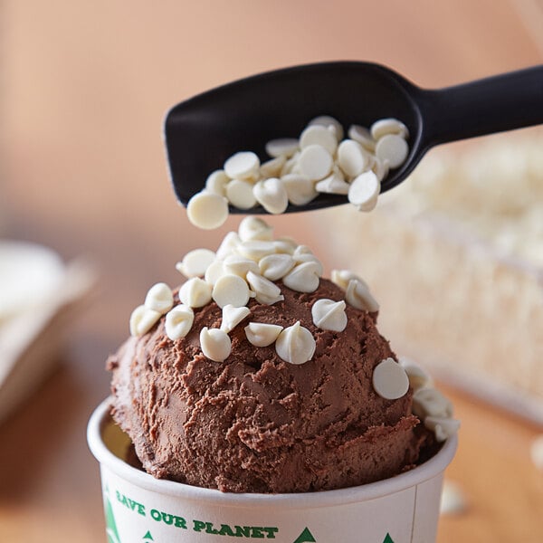 A scoop of chocolate ice cream with white chips.