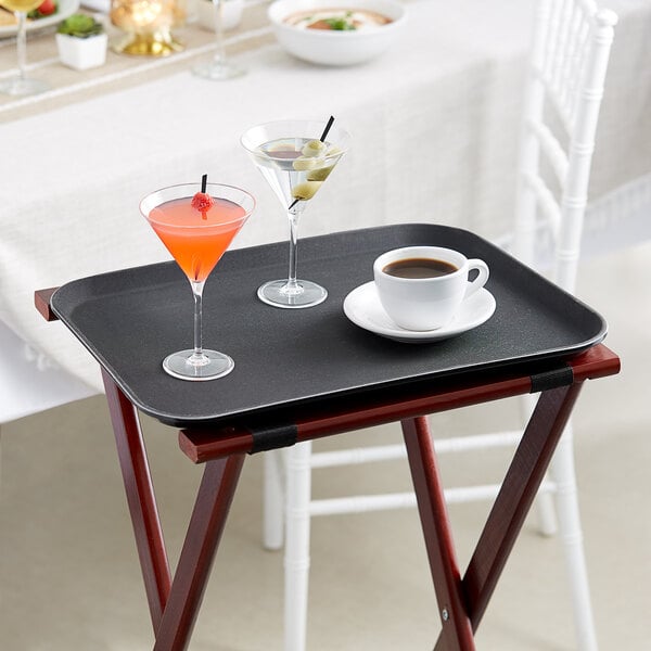 A black Choice rectangular non-skid serving tray with two martinis and a cocktail on it.