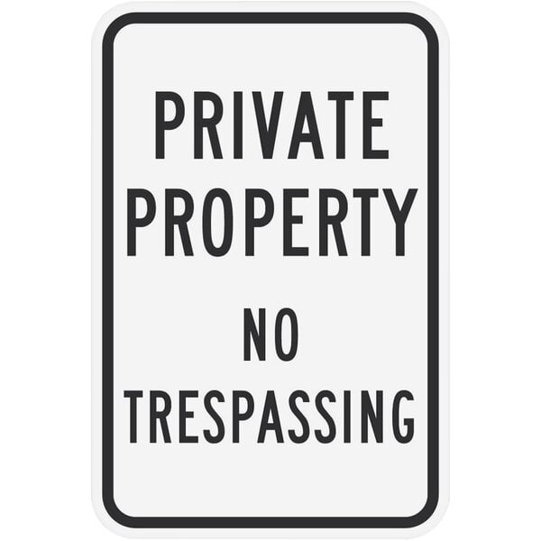 A white rectangular sign with black text that says "Private Property / No Trespassing"