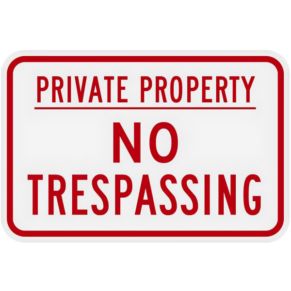 A white sign with red text that says "Private Property / No Trespassing"