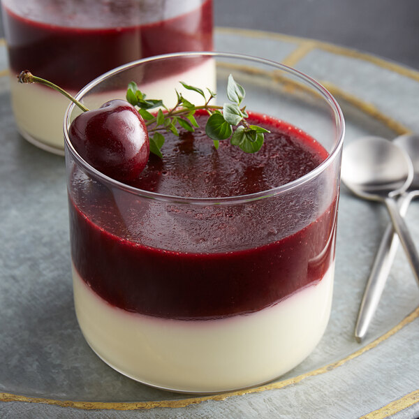Two dishes of dessert with Les Vergers Boiron Morello Cherry puree and a cherry on top.