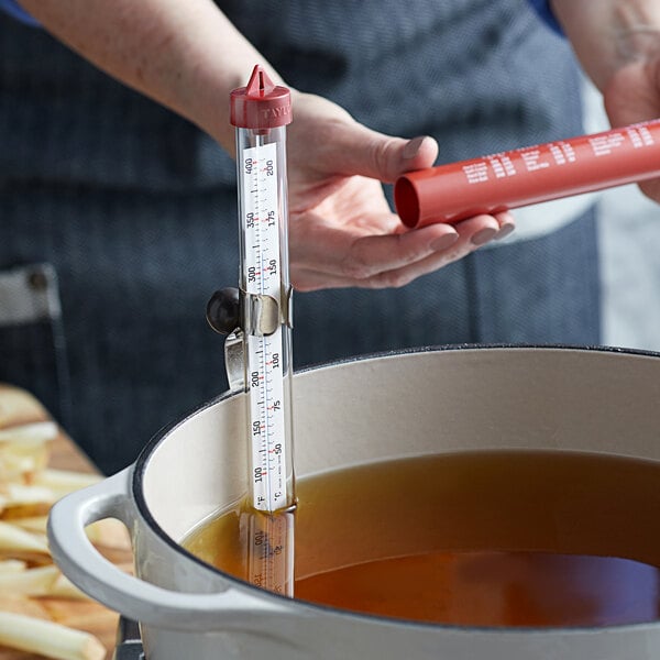 A Taylor candy/deep fry thermometer in a pot of liquid.