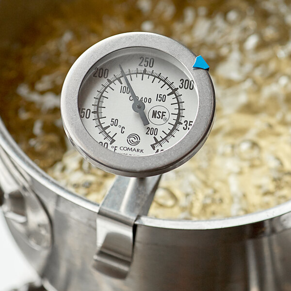 A Comark Candy / Deep Fry Probe Thermometer in a pot of boiling liquid.