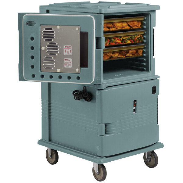A large grey Cambro Ultra Camcart with food inside a small oven.