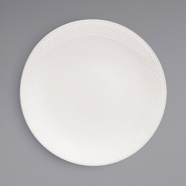 A white Front of the House porcelain plate with a spiral pattern.