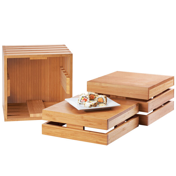 A wooden Cal-Mil crate riser with sushi on it.
