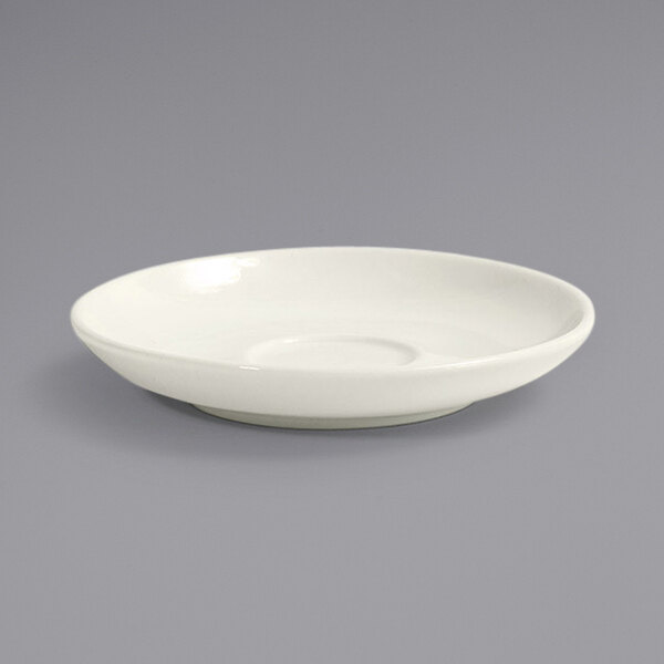 A white plate with a small bowl on top.