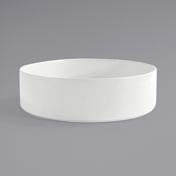 A Front of the House bright white porcelain bowl on a gray surface.