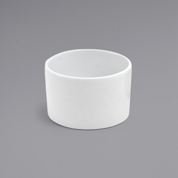 A Front of the House Soho bright white round porcelain ramekin on a gray background.