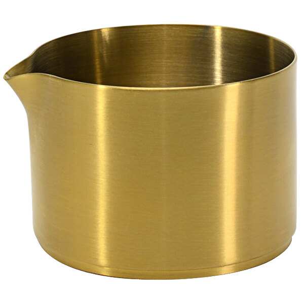 A gold metal pot with a spout and a handle.