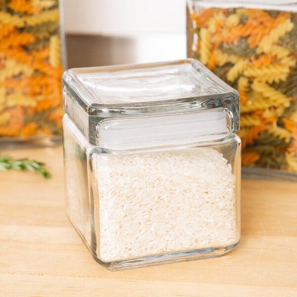 An Anchor Hocking clear glass square jar filled with white rice.