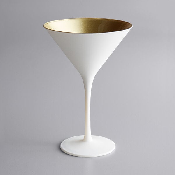 A white martini glass with a gold rim.