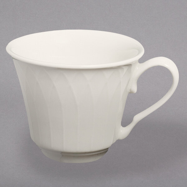 A white Homer Laughlin china cup with a handle.