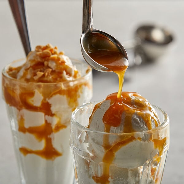 A spoon pouring I. Rice Caramel topping onto a sundae.