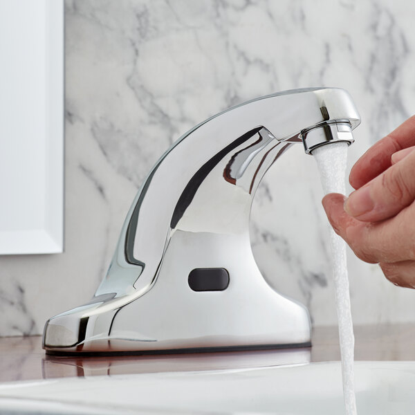 A person using a Waterloo hands-free sensor faucet to wash their hands.
