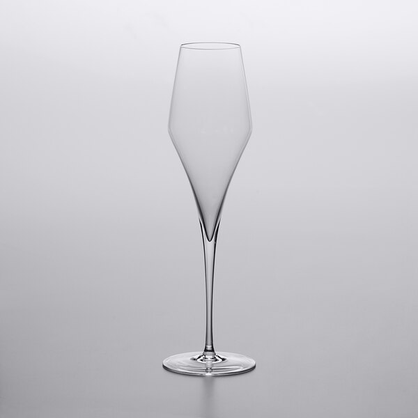 A clear Stolzle flute wine glass on a white surface.
