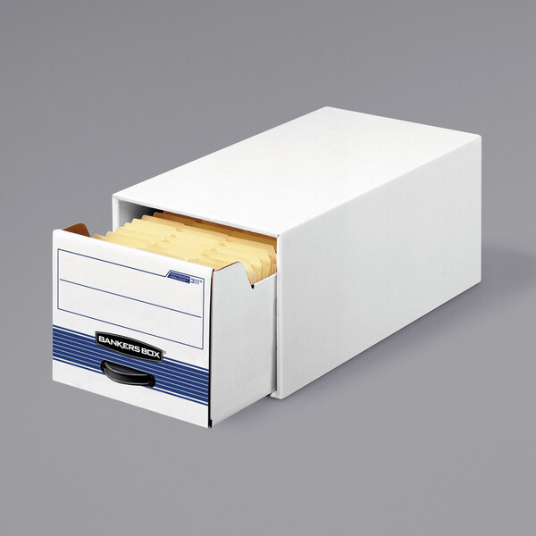 A white Banker's Box storage drawer with yellow file folders inside.