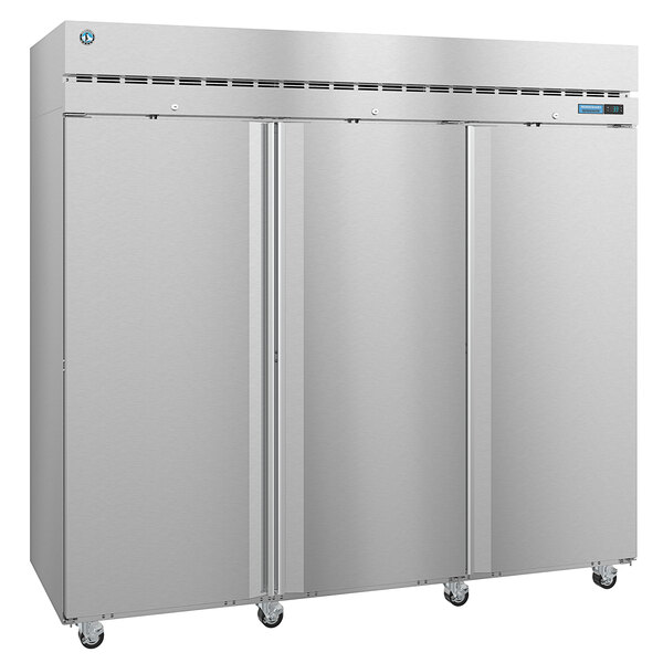 A large silver Hoshizaki reach-in refrigerator with stainless steel doors and wheels.