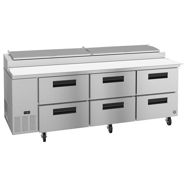 A stainless steel Hoshizaki refrigerated pizza prep table with 6 drawers.