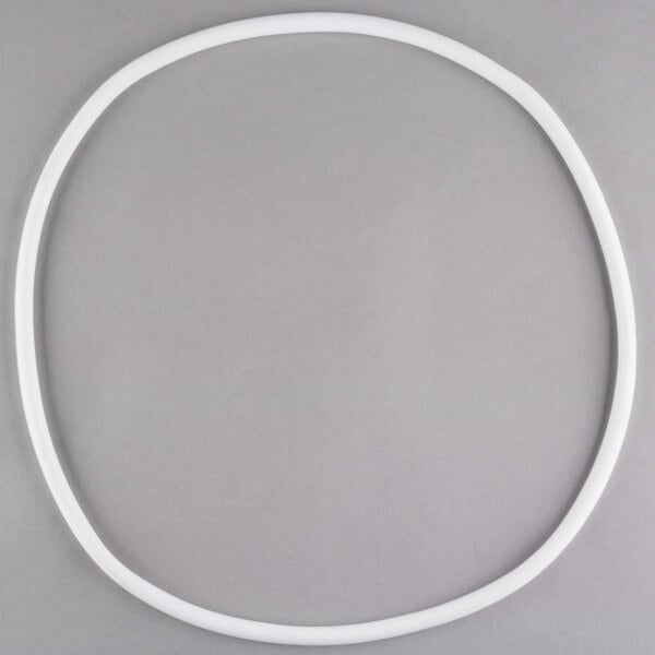 A white plastic ring with a white circle inside on a gray background.