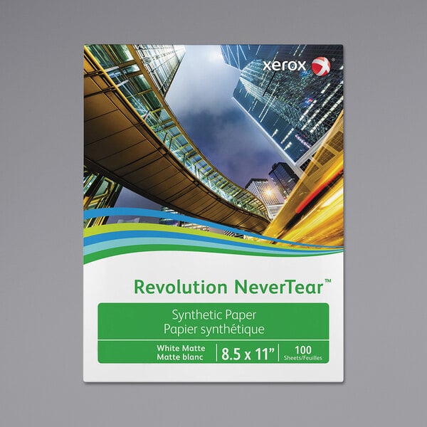 The white packaging of Xerox Revolution NeverTear photo paper with green and white labels and the words "Revolution NeverTear" and "Never"
