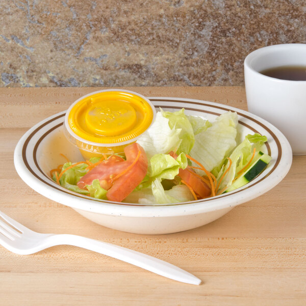 A Thunder Group Arcadia melamine salad bowl filled with salad on a counter.