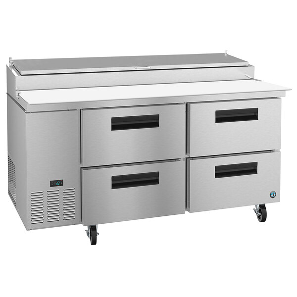 A stainless steel refrigerated pizza prep table with drawers.