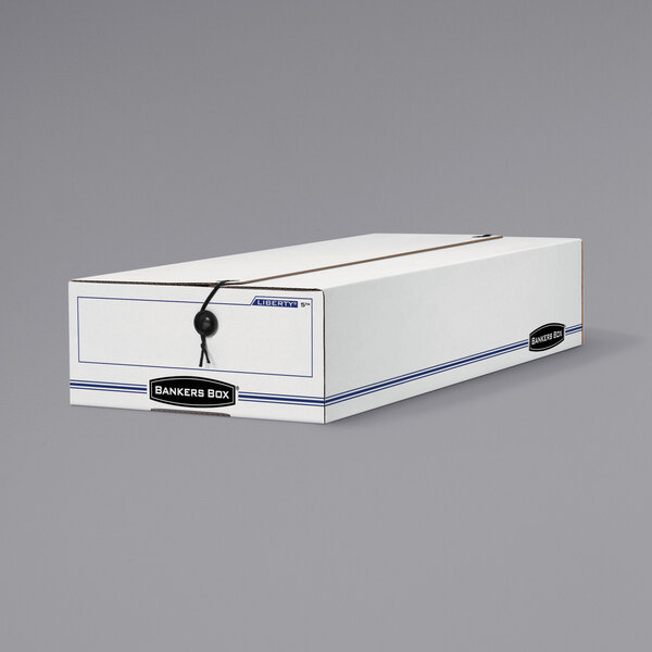 A white Banker's Box storage box with blue and white lines and a black string and button closure.