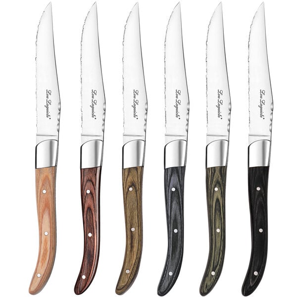 A group of Lou Laguiole steak knives with wooden handles in assorted colors.