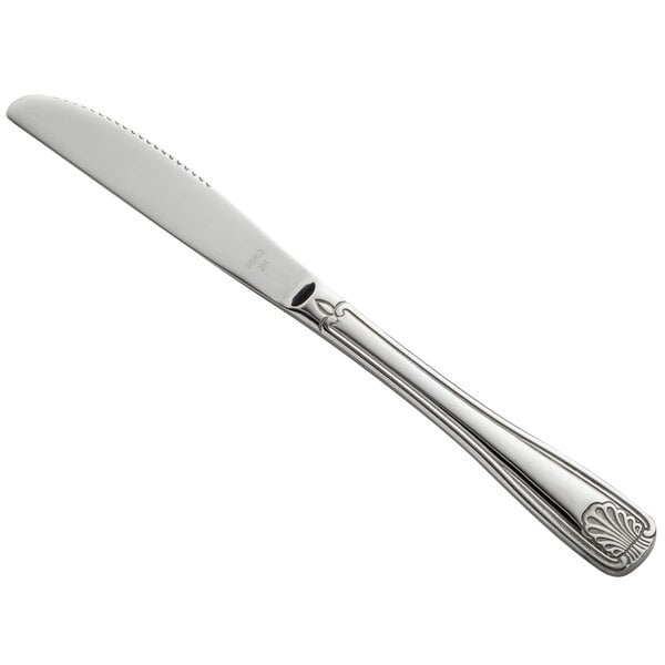 A silver World Tableware Coquille entree knife with a design on the handle.