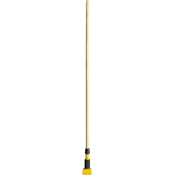 A long wooden Rubbermaid Gripper wood mop handle with a yellow jaw-style top.