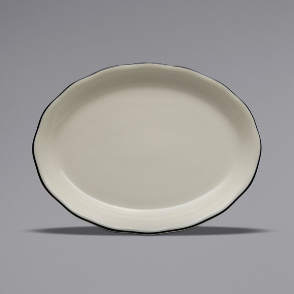 A white Oneida Buffalo oval platter with scalloped edges and black trim.