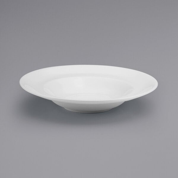 A white Oneida Buffalo porcelain deep pasta bowl on a gray surface.
